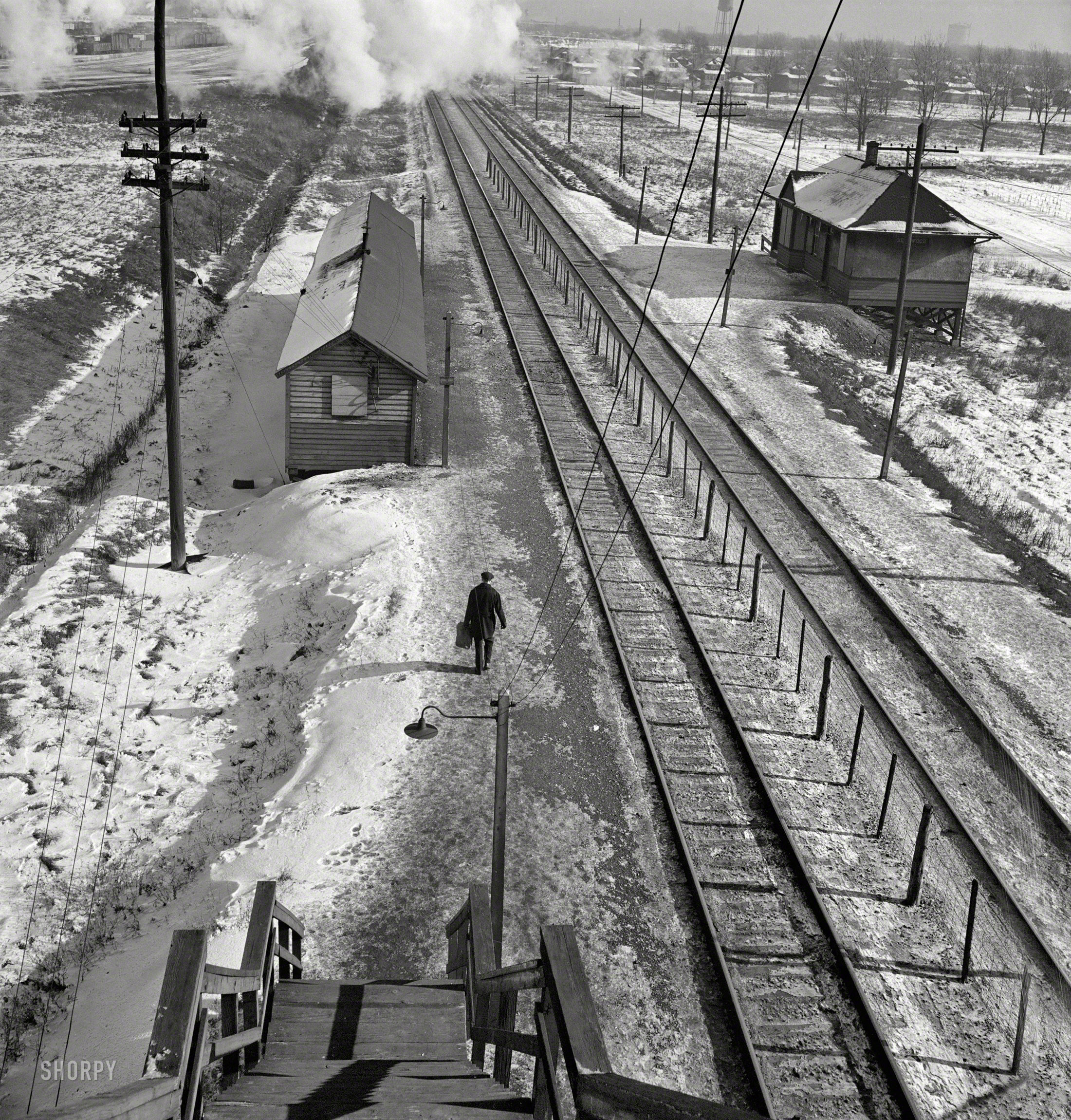 January 1943. "Freight operations on the Chicago & North Western R.R. between Chicago and Clinton, Iowa. The journey ended, conductor John M. Wolfsmith walks to the little passenger station to wait for a suburban train to take him home to Chicago." Photo by Jack Delano, Office of War Information. View full size.