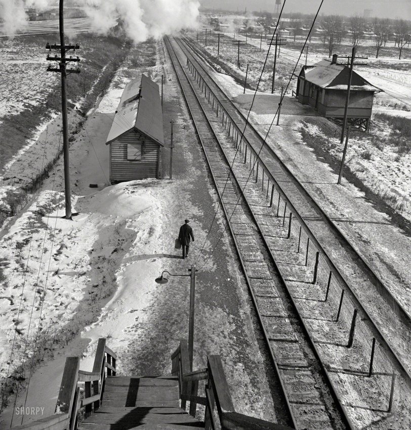 January 1943. "Freight operations on the Chicago &amp; North Western R.R. between Chicago and Clinton, Iowa. The journey ended, conductor John M. Wolfsmith walks to the little passenger station to wait for a suburban train to take him home to Chicago." Photo by Jack Delano, Office of War Information. View full size.

