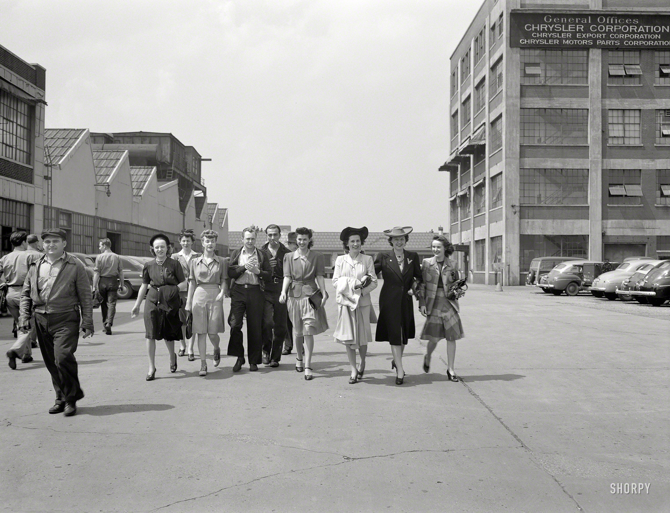 Spring 1942. "Detroit, Michigan. Girls coming out of the Highland Park Chrysler plant." Photo by Arthur Siegel for the Office of War Information. View full size.