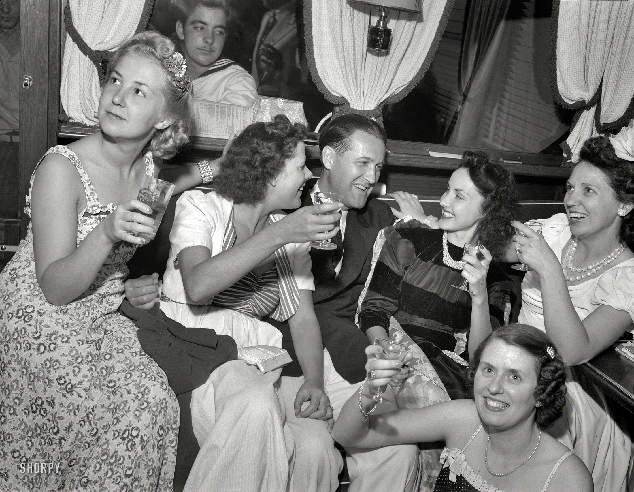 Summer 1940. "'Venetian Night' party at the Detroit Yacht Club, whose members represent the wealthier class of manufacturers. Commodore and girls drinking." Happy New Year from Shorpy! Photo by Arthur Siegel. View full size.