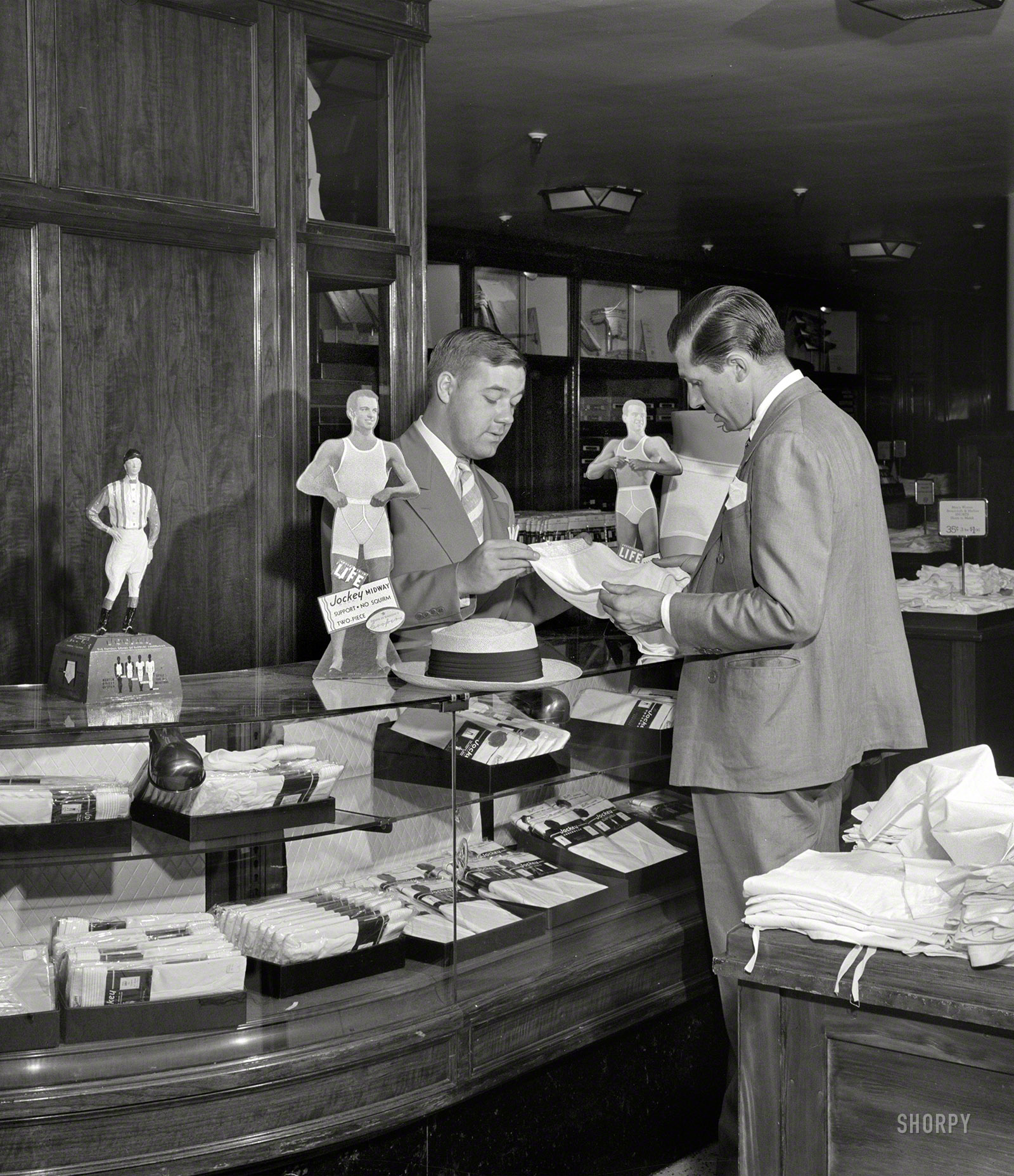 July 1941. "Detroit, Michigan. Buying men's shorts in the Crowley-Milner department store." Not just any shorts, but "No-Squirm" Jockeys. Large-format negative by Arthur Siegel for the Office of War Information. View full size.