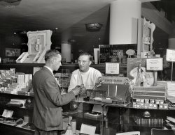 July 1941. "Detroit, Michigan. Men's toilet accessories department at the Crowley-Milner department store." Inspecting the Schick Shaver. Large-format nitrate negative by Arthur Siegel for the Office of War Information. View full size.