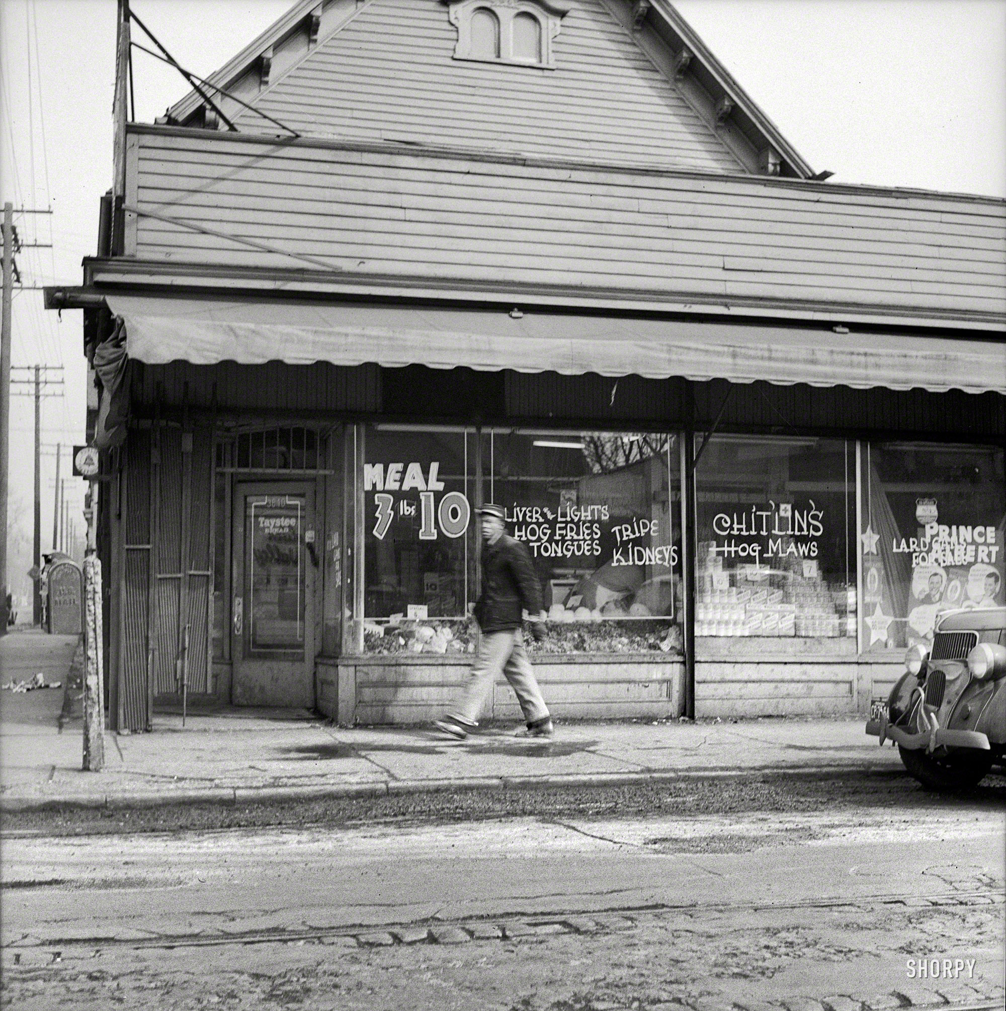 February 1942. Detroit, Michigan. "Sign in a grocery window in the Negro district: 'chitlins and hog maws'." Not to mention Taystee Bread. Medium-format nitrate negative by Arthur Siegel for the Office of War Information. View full size.