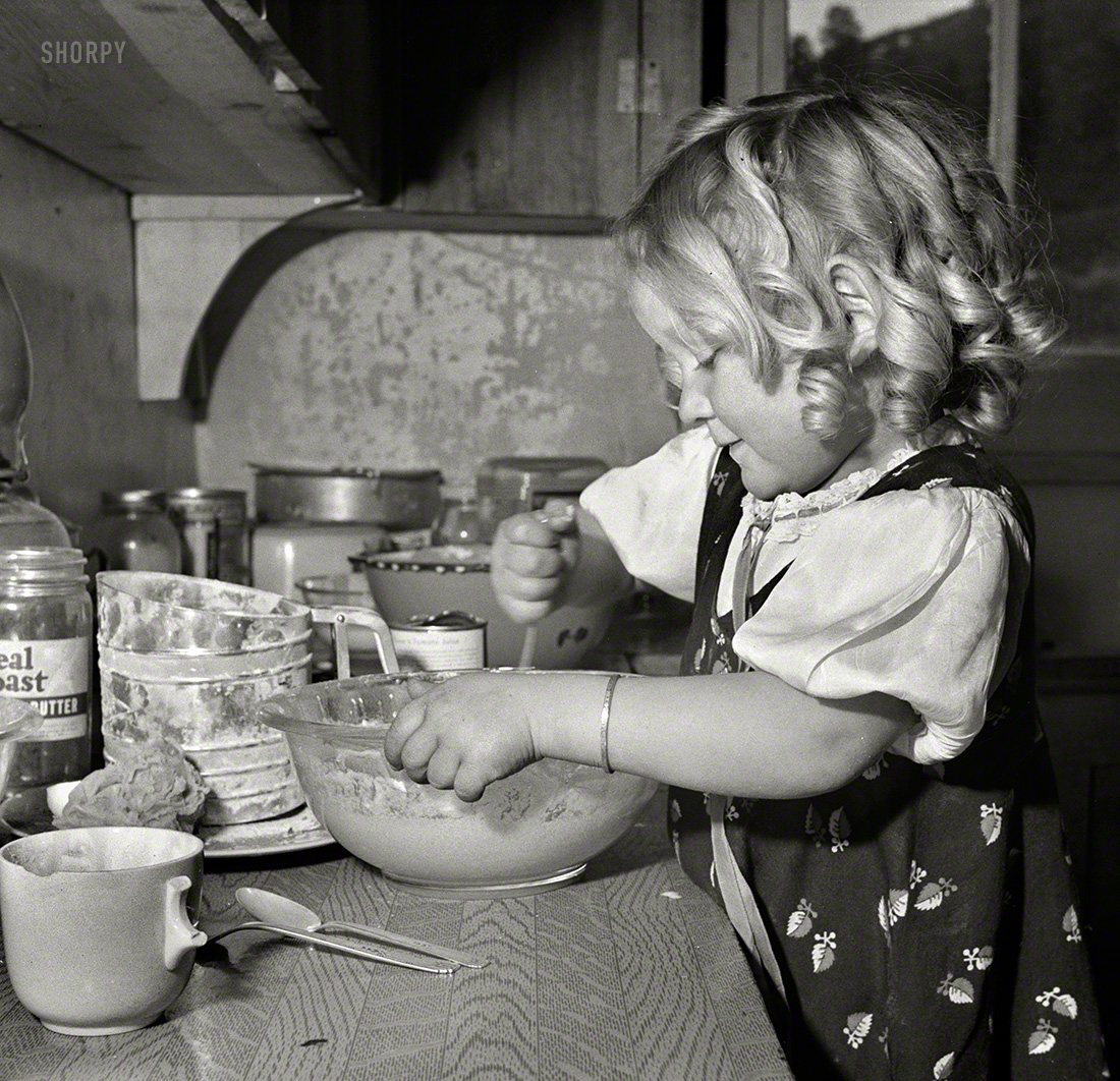 February 1943. Moreno Valley, Colfax County, New Mexico. "George Mutz's youngest daughter helping with the cooking." Not quite the Miracle Kitchen, but it'll do. Photo by John Collier, Office of War Information. View full size.