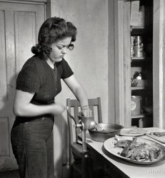 February 1943. "Moreno Valley, Colfax County, New Mexico. George Mutz's daughter grinding meat on the ranch." Our second look at Mary Mutz in the kitchen. Photo by John Collier for the Office of War Information. View full size.
