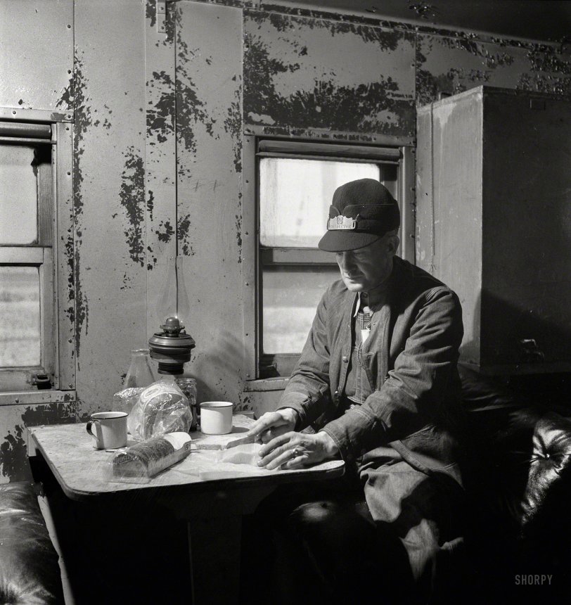 March 1943. "Conductor George E. Burton, having lunch in the caboose on the Atchison, Topeka &amp; Santa Fe between Chicago and Chillicothe." Medium-format negative by Jack Delano for the Office of War Information. View full size.
