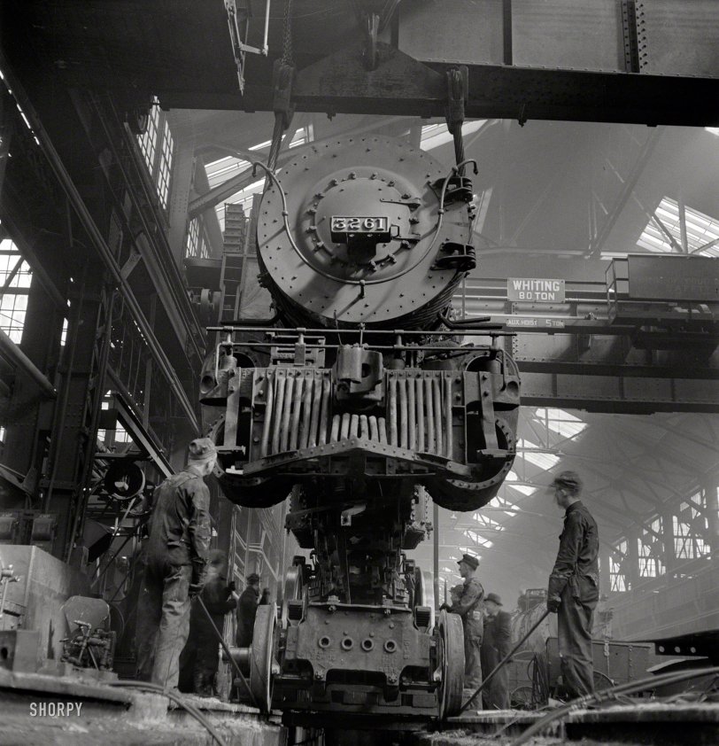 March 1943. "Topeka, Kansas. Wheeling an engine in the Atchison, Topeka &amp; Santa Fe locomotive shops." Photo by Jack Delano. View full size.

