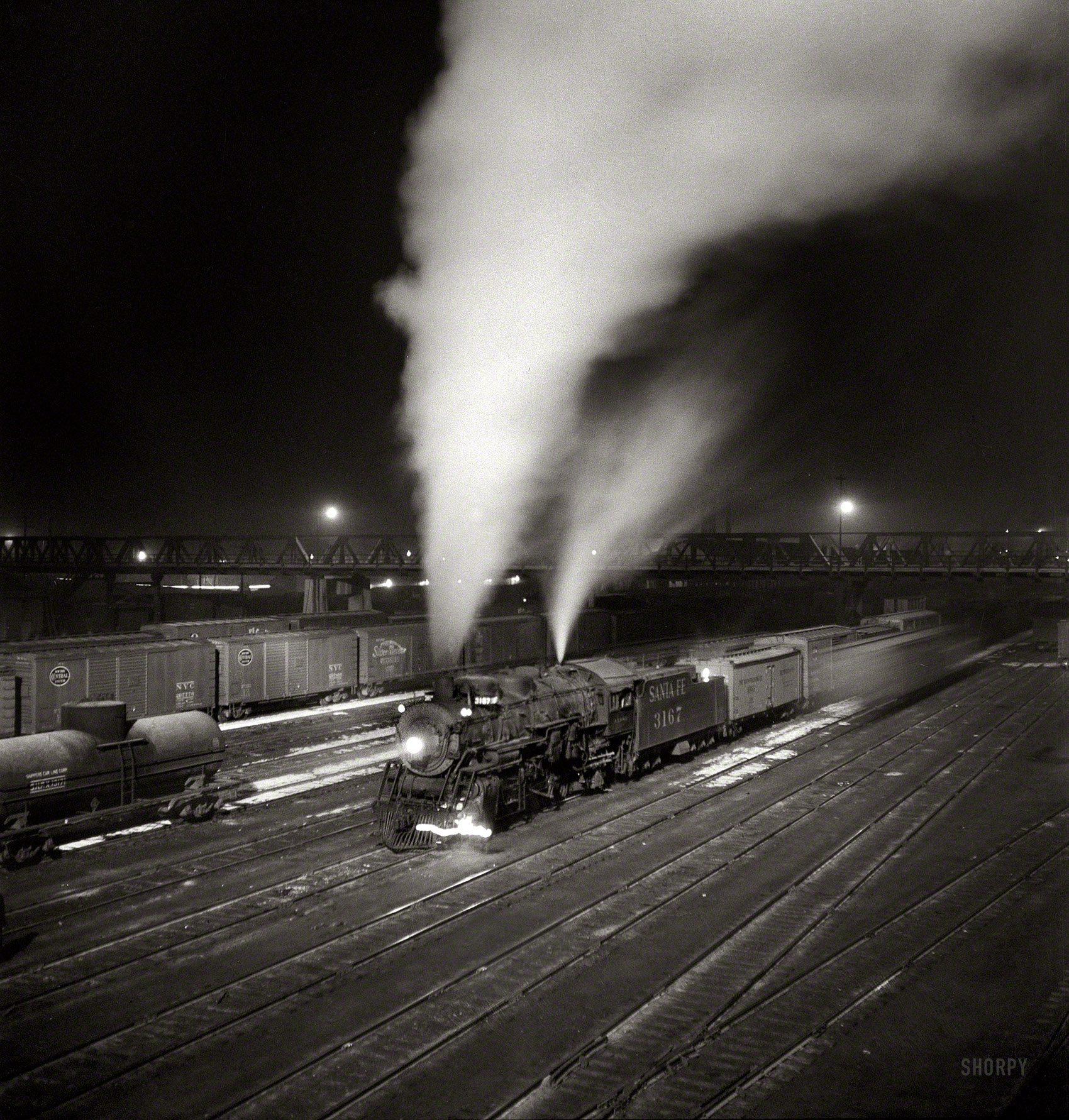 March 1943. Argentine, Kansas. "Freight train about to leave the Atchison, Topeka & Santa Fe Railroad yard for the West Coast." Medium-format nitrate negative by Jack Delano for the Office of War Information. View full size.