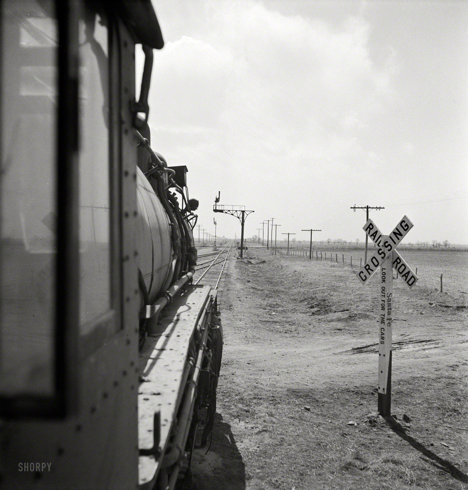 March 1943. "Kiowa (vicinity), Kansas. Train waiting for a block signal along the Atchison, Topeka & Santa Fe Railroad." Photo by Jack Delano. View full size.