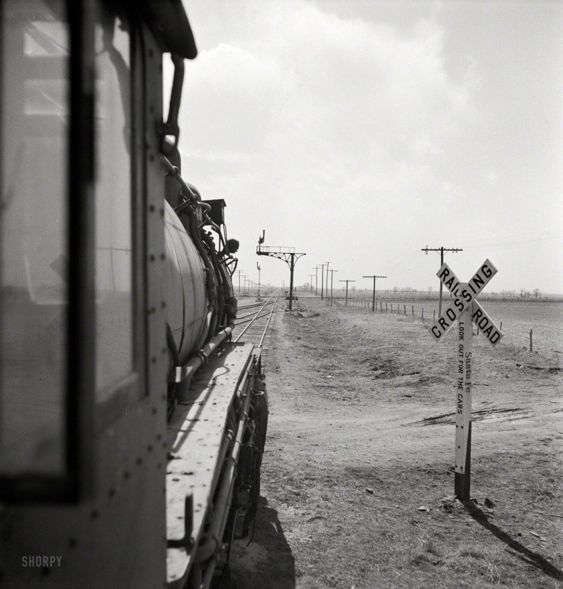 March 1943. "Kiowa (vicinity), Kansas. Train waiting for a block signal along the Atchison, Topeka &amp; Santa Fe Railroad." Photo by Jack Delano. View full size.
