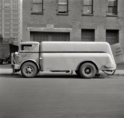 March 1943. "New York, New York. Department of Sanitation street flushing sprinkler truck." One in a series of photos taken by John Vachon for the Office of War Information documenting trucks in the Northeast. View full size.
Double FlushingIt would be even better if the truck were in Flushing, as the headline could be Flushing Flushing New York.
Olde Buck&#039;s other half___ FAT PENSION IS
____ TO FUND.
_____ __ COMING!
It saysOUR CITY,
YOURS &amp; MINE.
KEEP IT CLEAN.
The Other HalfI wonder what the words are on the right rear door?
OUR ---
YOURS ---
KEEP IT ---
I can only guess that the last word is CLEAN.
1933 Autocar Model UT450 1933 Autocar Model UTs were delivered to NYC. See here.
Three S&#039;sSnow plow, Suicide door and Semaphore signal.  The monster front bumper is typical for snow plow mounting and is used by many city works trucks to this day.  The suicide door in this case was an easy answer to deal with cab access.  The semaphore turn signal, to the rear of the drivers door window mimicked arm signals and had a lever mounted in the cab most likely connected with a cable.
re: 1933 AutocarIt's amazing how little trucks have changed over the years compared to cars.  This 80-year-old vehicle would not look completely out of place if you'd see it performing similar duties in a big city today.  
A good design lasts foreverThe interesting thing is that the design of those street flushing trucks has barely changed since the 1940's. They are still a heavy truck frame with a large water tank in the back and a second smaller motor that runs a pump behind the rear axle (the reason for those large "barn doors" on the back of the tank).  The nozzles that spray the water are identical to the ones you would find on a brand new street flusher today.
(The Gallery, Cars, Trucks, Buses, NYC)
