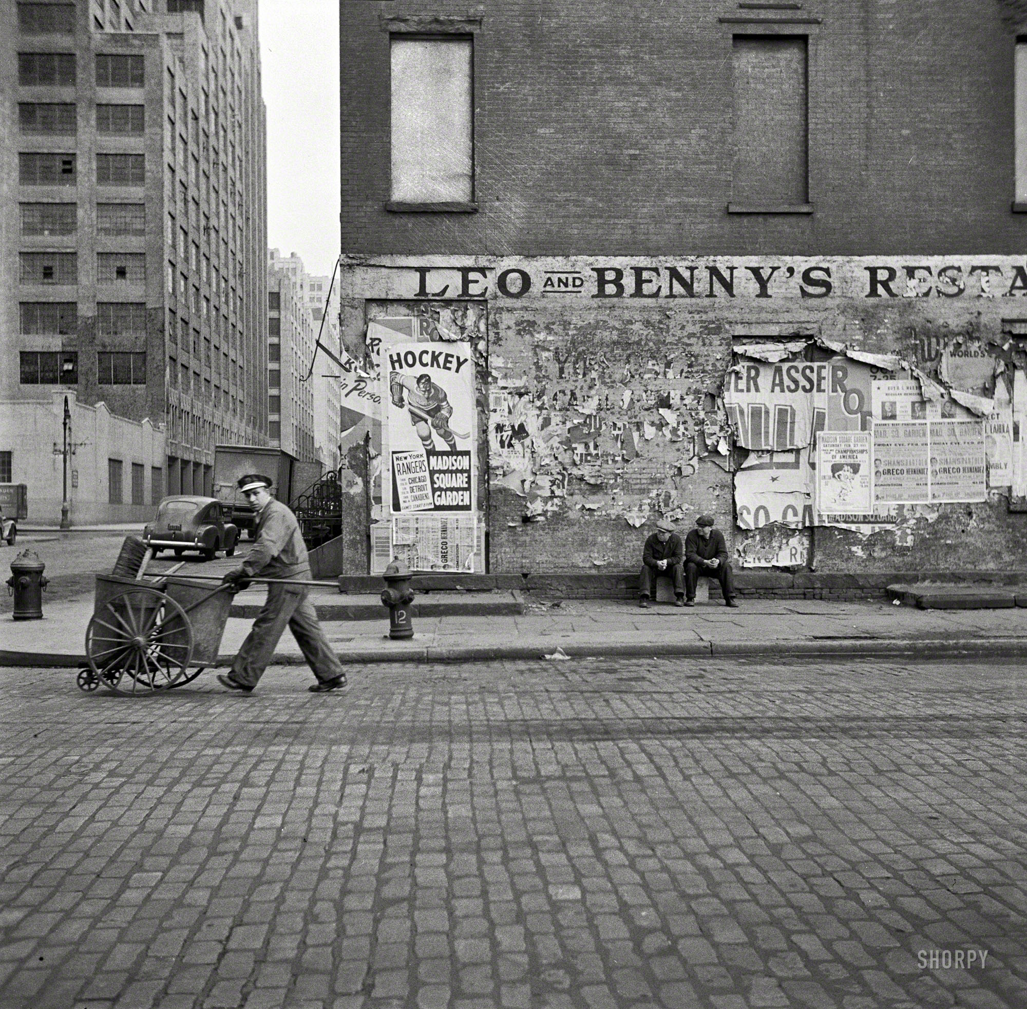 March 1943. New York. "A street cleaner on Washington Street."  Medium format negative by John Vachon for the Office of War Information. View full size.