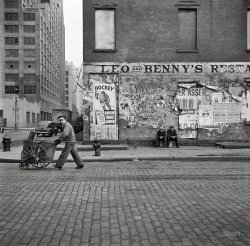 March 1943. New York. "A street cleaner on Washington Street."  Medium format negative by John Vachon for the Office of War Information. View full size.
Nineteen Forty!!!I would love to go back in time to tell any Ranger fans lurking about New York in 1943 that, even though their team had won three Stanley Cups in their 17 year history in the NHL (1927, 1933 and 1940), it would be more than fifty years before a player in a Rangers uniform would hoist the Cup again (1994). 
Original NHL sixOh, I do so love that large poster advertising Rangers games at the Garden, curiously listing the Black Hawks and Red Wings by their city names but Montreal by its team name.  Plus the truck up the street with its side door open, and the two seated guys, and the look of the passing street cleaner, and a restaurant named Leo and Benny's.  There's so much great stuff in this delicious photo!
Oops!Love how the street sweeper is looking at the camera as he walks right past the trash in the street.
Leo &amp; Benny&#039;sThis particular dining establishment must have washed its last greasy spoon in the 1930s.  There is no entry for "Leo and Benny's" in the 1940 Manhattan Telephone Directory. 
StoryMakes you wonder about the story behind "Leos and Benny's", brothers? Chums?  Think the two fellas sittin' there are hoping for a re-opening. Or maybe that's Leo and Benny trying to decide what to try next.
Fight cardIn the fights at Madison Square Garden advertised on the poster at right (which already had taken place by the photo date), Johnny Greco won a decision over Cleo Shans in a ten-round lightweight match, while Sal "The Pride of East Boston" Bartolo outpointed Pedro Hernandez in a 10-round featherweight match.
Trivia: this was the first of the 12 fights that Bartolo would have in 1943.  Today a boxer who fights 12 times in five years would be considered unusually active.  Boxers were a tougher breed back then.
High LinerWashington Street is in the heart of the very trendy Meatpacking District. The area is also part of the new High Line Park neighborhood. You can rent a 1 bedroom apartment in the $5,000 a month realm or buy one in a condo for about $2 million. Too bad Leo &amp; Benny couldn't hang around longer.
Attached is a view of the Meatpacking District that I took a few years ago as I was walking through the High Line Park.
Real hockey fansknow that you never put "Ice" before hockey, it's a Canadian thing, and no sissy helmets back then.
Charlton &amp; WashingtonThe corner of Charlton &amp; Washington with Greenwich St in the distance.  The cameraman is standing on Washington St looking east.  Today, Charlton St no longer extends to Washington, the UPS distribution center is now built there.  The building in the background is 345 Hudson St.  Standard and Poor's moved into 345 Hudson in 1930.
re: Original NHL sixMy thinking is that the team was referred to as the Canadiens and not Montreal because there was another team from Montreal named the Maroons. While the Maroons were basically defunct as of 1938 and didn't play for several seasons they were still technically a part of the league until the mid-40s I think.
MaroonsInteresting speculation, sanman9781, but the last time the Maroons played was 1938, and this is 5 years later, so I don't think anyone would need clarification on which team was Montreal.  By the way, it was back to just the original six in 1942-43 (Black Hawks, Maple Leafs, Red Wings, Canadiens, Bruins and Rangers), and the Stanley Cup was won a month later by Detroit.
The Myth Of The Original SixBoth sanman9781 and davidk are technically correct. The NHL was down to the six teams that would come to be known as the "Original Six" in the 1942-43 season, both the Montreal Maroons and Brooklyn Americans (previously the New York Americans) franchises existed although both were suspended. In the case of the Americans the League had promised to revive the team after the end of the war, a promise that was reneged upon in 1946. The American's owner "Red" Dutton was convinced that the cancellation of the franchise was demanded by the owners of the New York Rangers. He cursed the Rangers saying that they wouldn't win another Stanley Cup in his lifetime. They didn't win the Cup again until 1994, seven years after Dutton's death.
Actually the NHL didn't go "back to just the original six in 1942-43" simply because that was the first season in which the so-called "Original Six" alignment of teams existed. The NHL's first season - 1917-18 - started with five teams and ended with three: Montreal Canadiens, Ottawa Senators, Toronto St. Patricks, Quebec Bulldogs (didn't start the season though they'd be back in 1919-20) and Montreal Wanderers (who started the season but withdrew when their arena burned down). The notion of the "Original Six" only came about after the equally misnamed "first expansion" in the 1967-68 season - misnamed because the NHL had expanded from the three teams that finished the 1917-18 season to ten teams by the 1925-26 season.
(The Gallery, John Vachon, NYC)