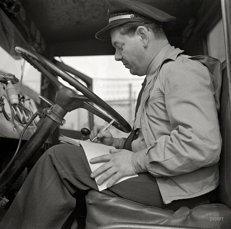 March 1943. Washington, D.C. "Bob Daugherty filling out his log book after lunch. The Interstate Commerce Commission requires all truck drivers to keep time records." Photo by John Vachon, Office of War Information. View full size.
