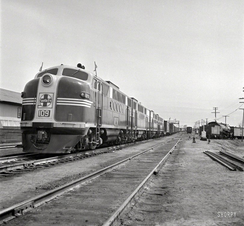 March 1943. "Flagstaff, Arizona. Diesel locomotive entering town along the Atchison, Topeka &amp; Santa Fe Railroad between Winslow and Seligman." Photo by Jack Delano for the Office of War Information. View full size.
