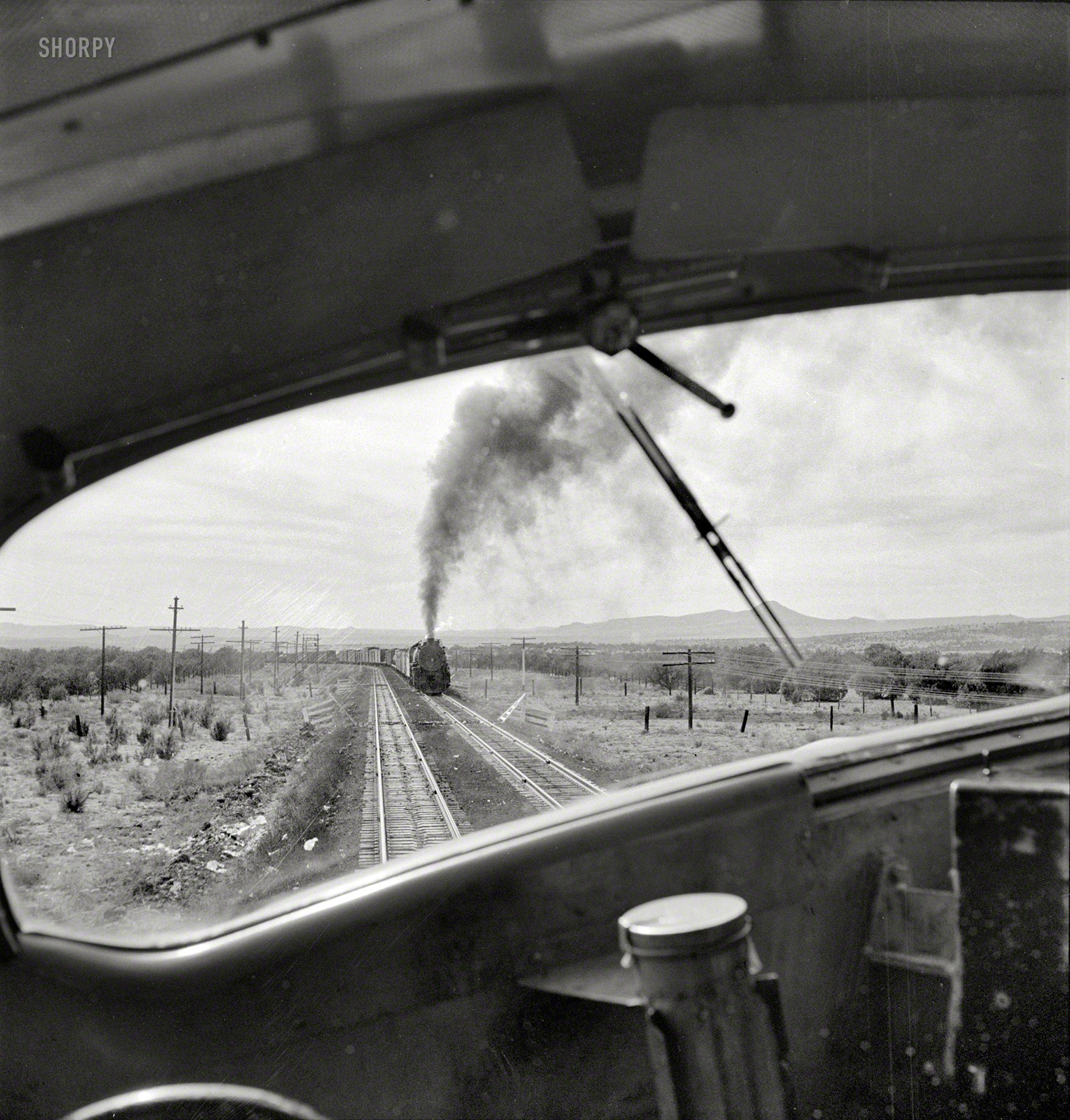 March 1943. "Ash Fork, Arizona (vicinity). Passing an eastbound freight on the Atchison, Topeka & Santa Fe Railroad between Winslow and Seligman." Medium-format negative by Jack Delano, Office of War Information. View full size.