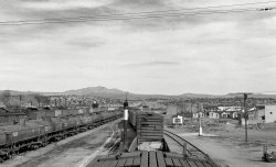 March 1943. "Ash Fork, Arizona. Pulling into the Atchison, Topeka & Santa Fe railyard." With much helpful signage. Photo by Jack Delano. View full size.