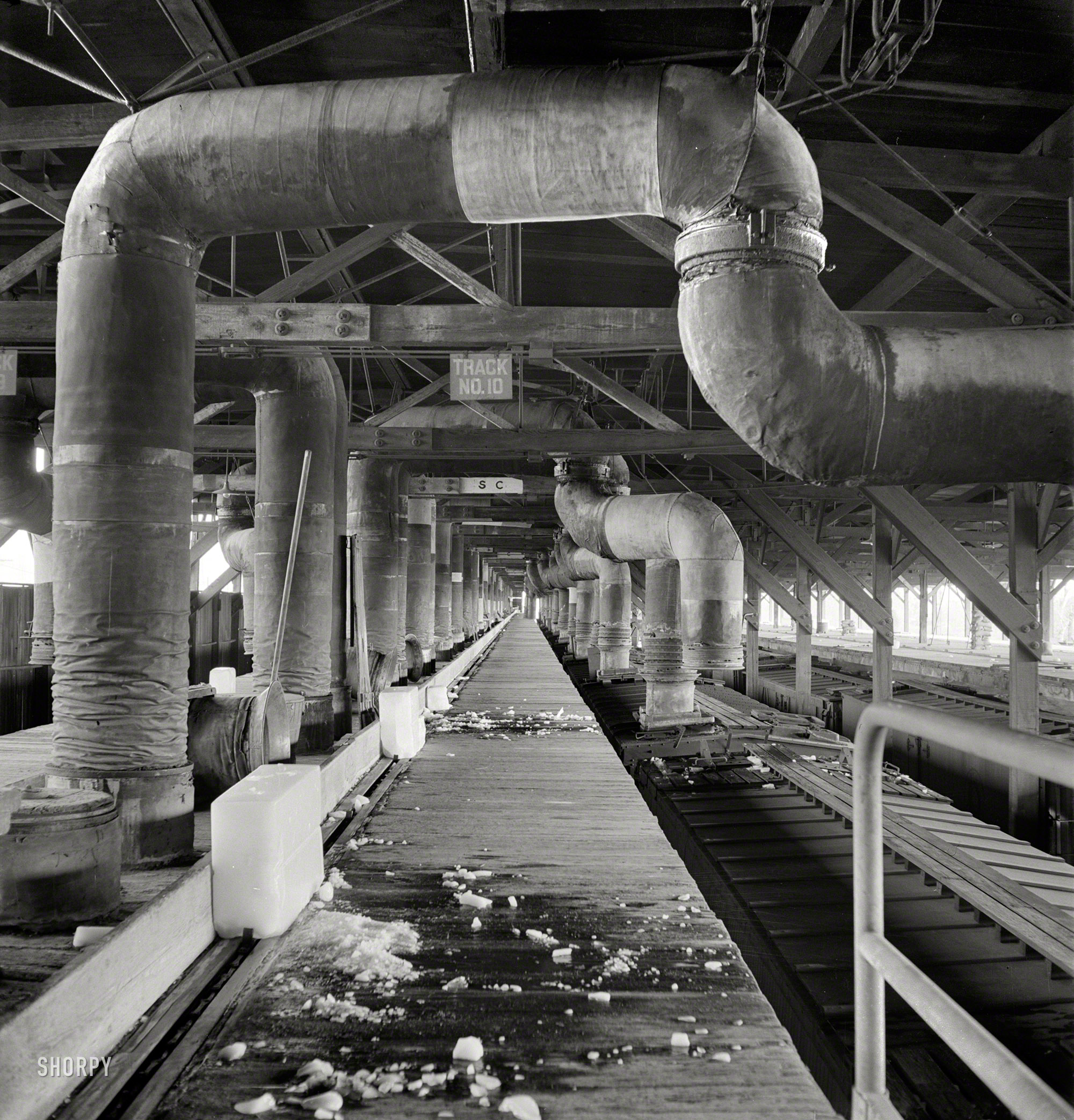 March 1943. "San Bernardino, California. Cars being precooled at the ice plant. Air at a temperature of 20 degrees Fahrenheit is blown through the cars for 20 minutes in one direction, then in the other. Shippers specify the number of hours precooling required for their product." Photo by Jack Delano. View full size.