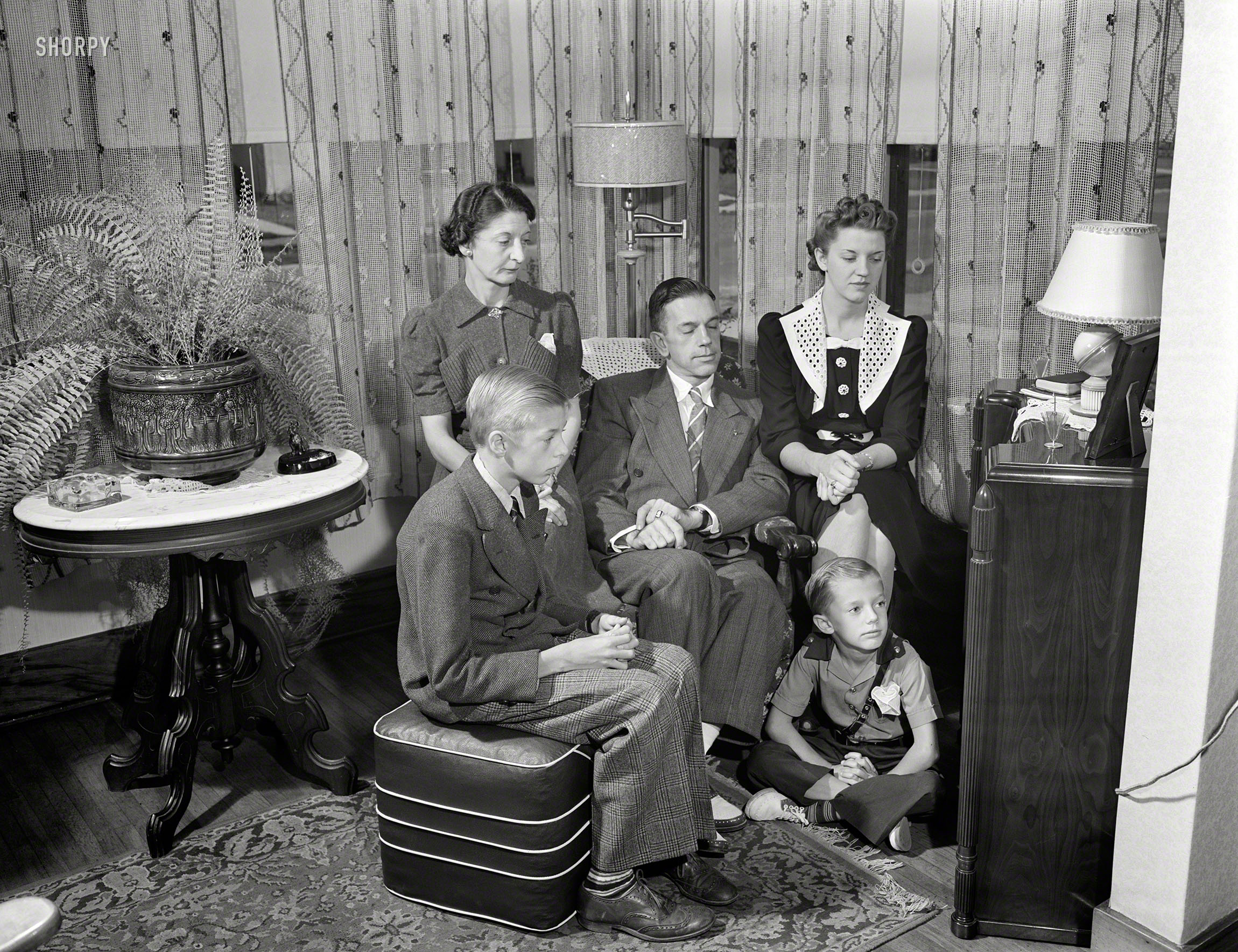 September 1942. Rochester, New York. "The Babcocks, an American family, tuning in for war news. Mr. and Mrs. Babcock with children Shirley, Howard and Earl, the youngest." Photo by Ralph Amdursky, Office of War Information. View full size.