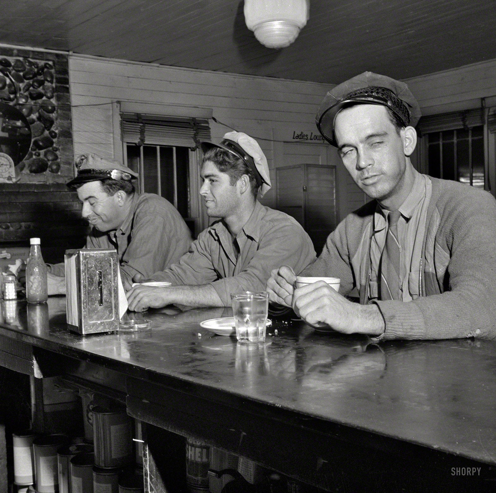 March 1943. "Pearlington, Mississippi (vicinity). Truck drivers at a highway coffee stop on U.S. Highway 90." Who's up for a slice of apple pie? Medium format negative by John Vachon, Office of War Information. View full size.