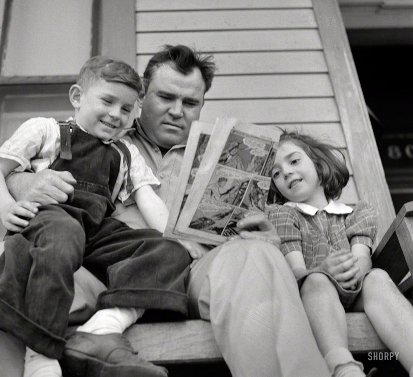 March 1943. Montgomery, Alabama. "Marvin Johnson, truck driver, reading the 'funnies' to his children." Happy Father's Day from Shorpy! Photo by John Vachon for the Office of War Information. View full size.
