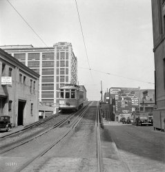 April 1943. "Baltimore, Maryland. Elevated trolley." A restaurant, gas station, public transportation and booze all in one handy view. Photo by Marjory Collins for the Office of War Information. View full size.