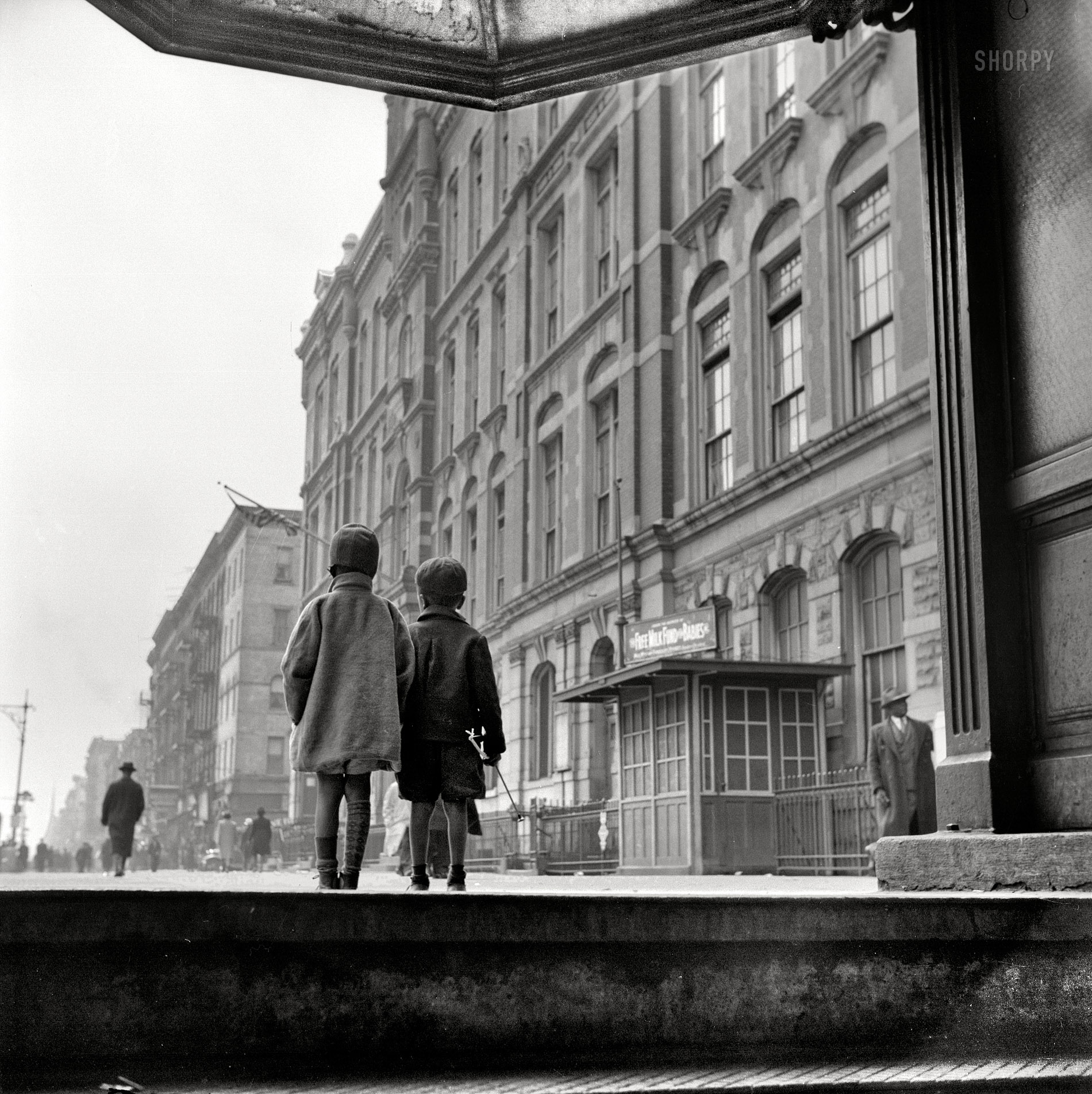 Spring 1943. "A Harlem scene." Viewed from the subway entrance. Medium-format negative by Gordon Parks, Office of War Information. View full size.
