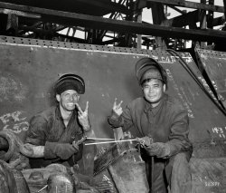 May 1943. Baltimore, Maryland. "Electric welders working on the Liberty ship Frederick Douglass at the Bethlehem-Fairfield shipyards." Photo by Roger Smith for the Office of War Information. View full size.