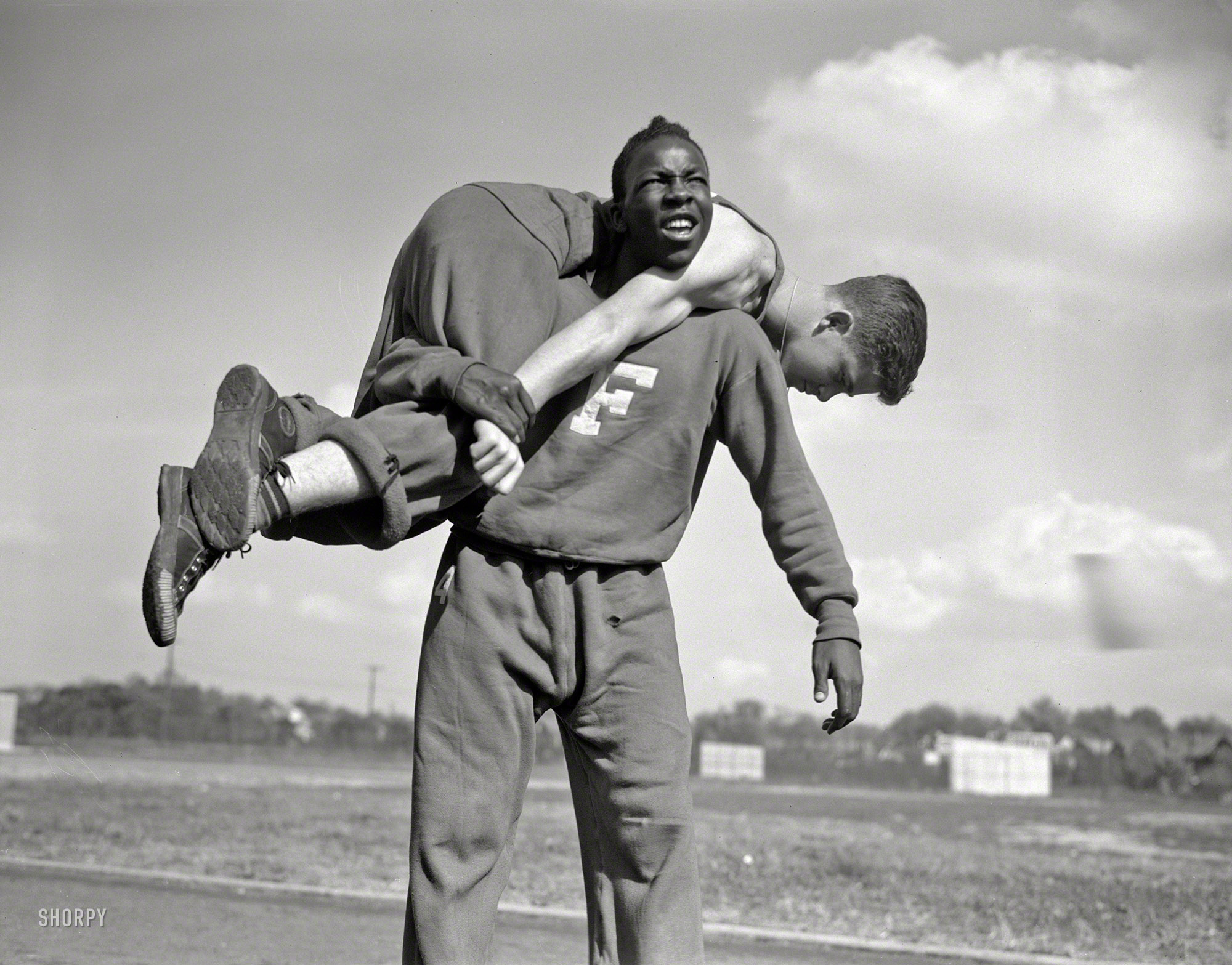 October 1942. "High school Victory Corps. The 'fireman's carry.' Method of carrying a wounded comrade is shown here by boys in the 'commando' course of the physical education program at Flushing High School, Queens, New York." Photo by William Perlitch for the Office of War Information. View full size.