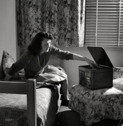 June 1943. "Arlington, Virginia. Girl in her room playing phonograph at Arlington Farms, a residence for women who work in the government for the duration of the war." Photo by Esther Bubley, Office of War Information. View full size.