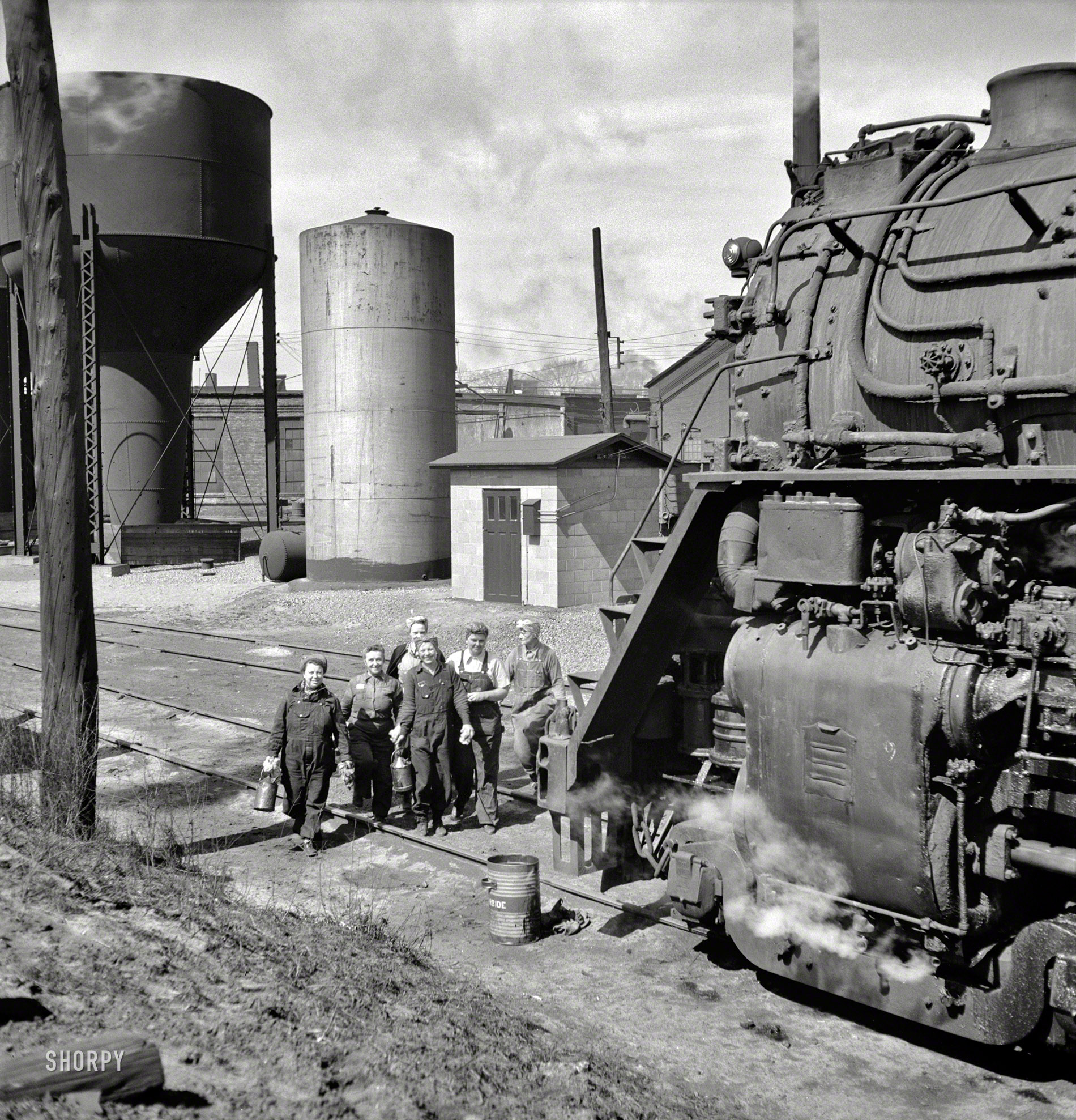 May 1943. Clinton, Iowa. "Women wipers of the Chicago & North Western Railroad going out to work on an engine at the roundhouse." Medium-format negative by Jack Delano for the Office of War Information. View full size.