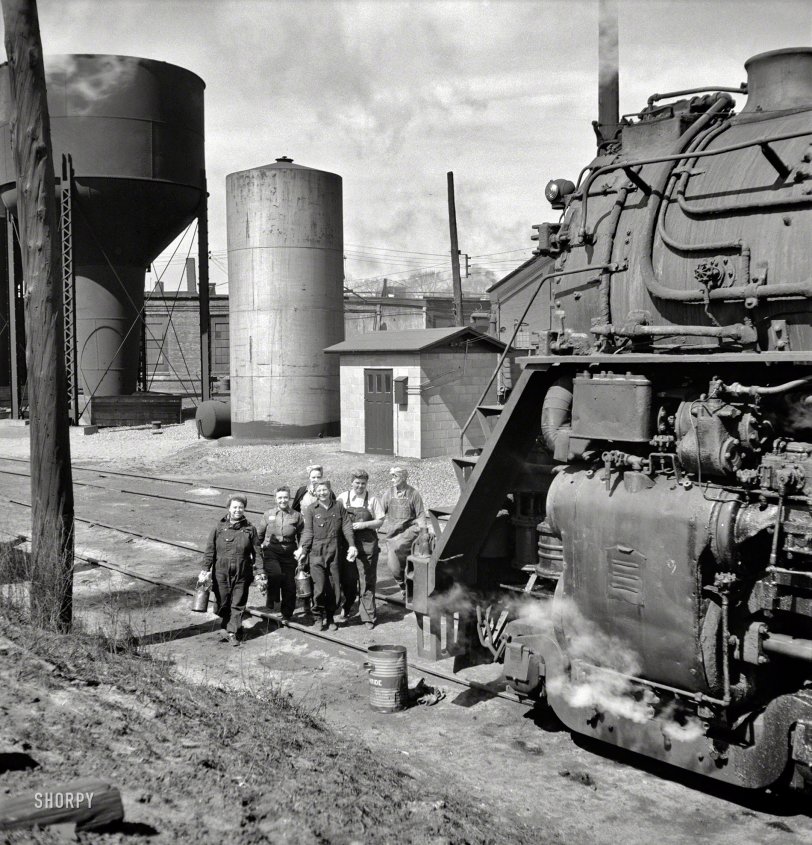 May 1943. Clinton, Iowa. "Women wipers of the Chicago &amp; North Western Railroad going out to work on an engine at the roundhouse." Medium-format negative by Jack Delano for the Office of War Information. View full size.
