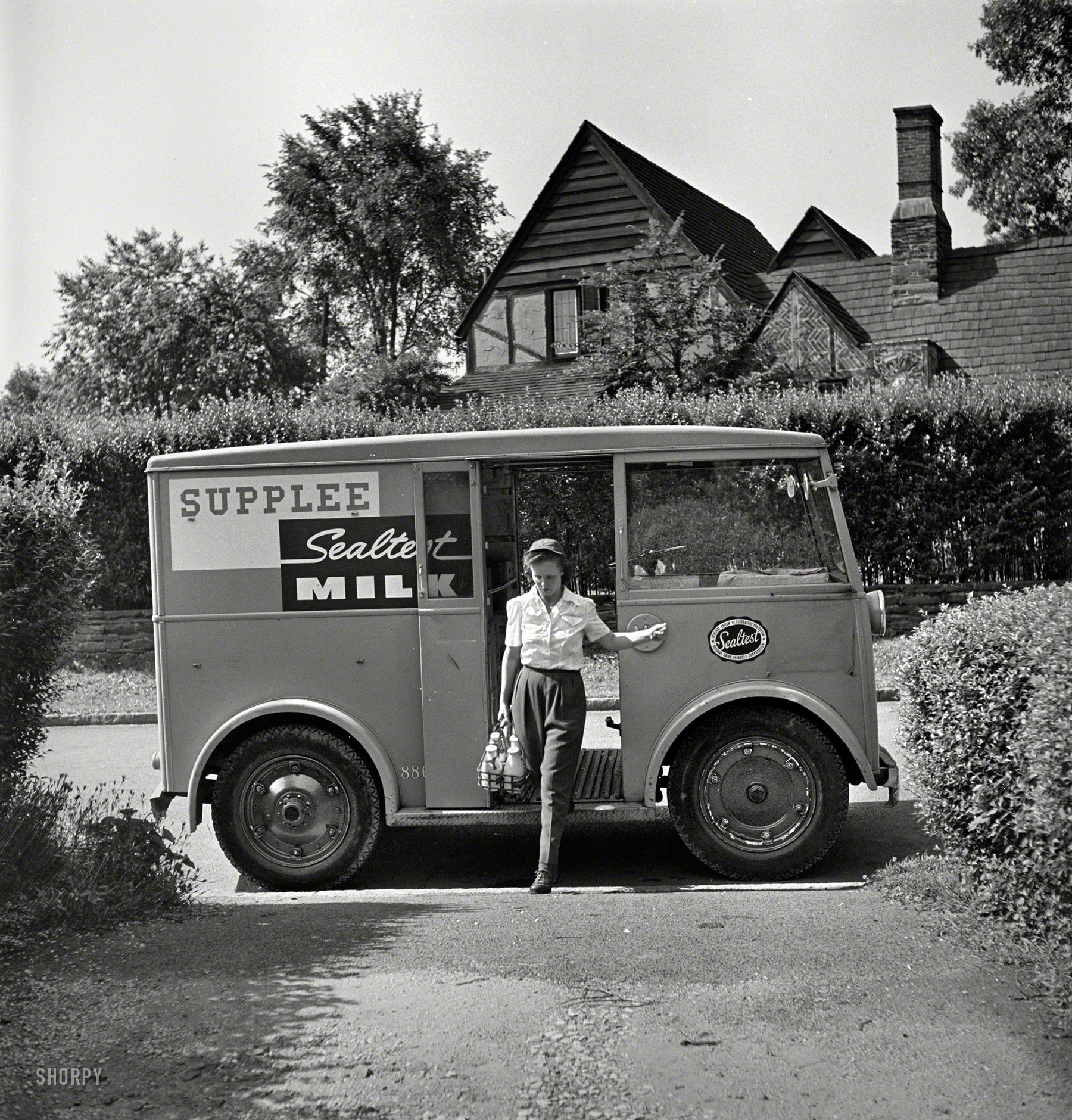 June 1943. Bryn Mawr, Pa. Our second visit with Mrs. Helen Joyce, "one of the many women who now work for the Supplee-Wills-Jones Milk Co." Piloting a little Walker electric delivery van. Photo by Jack Delano. View full size.