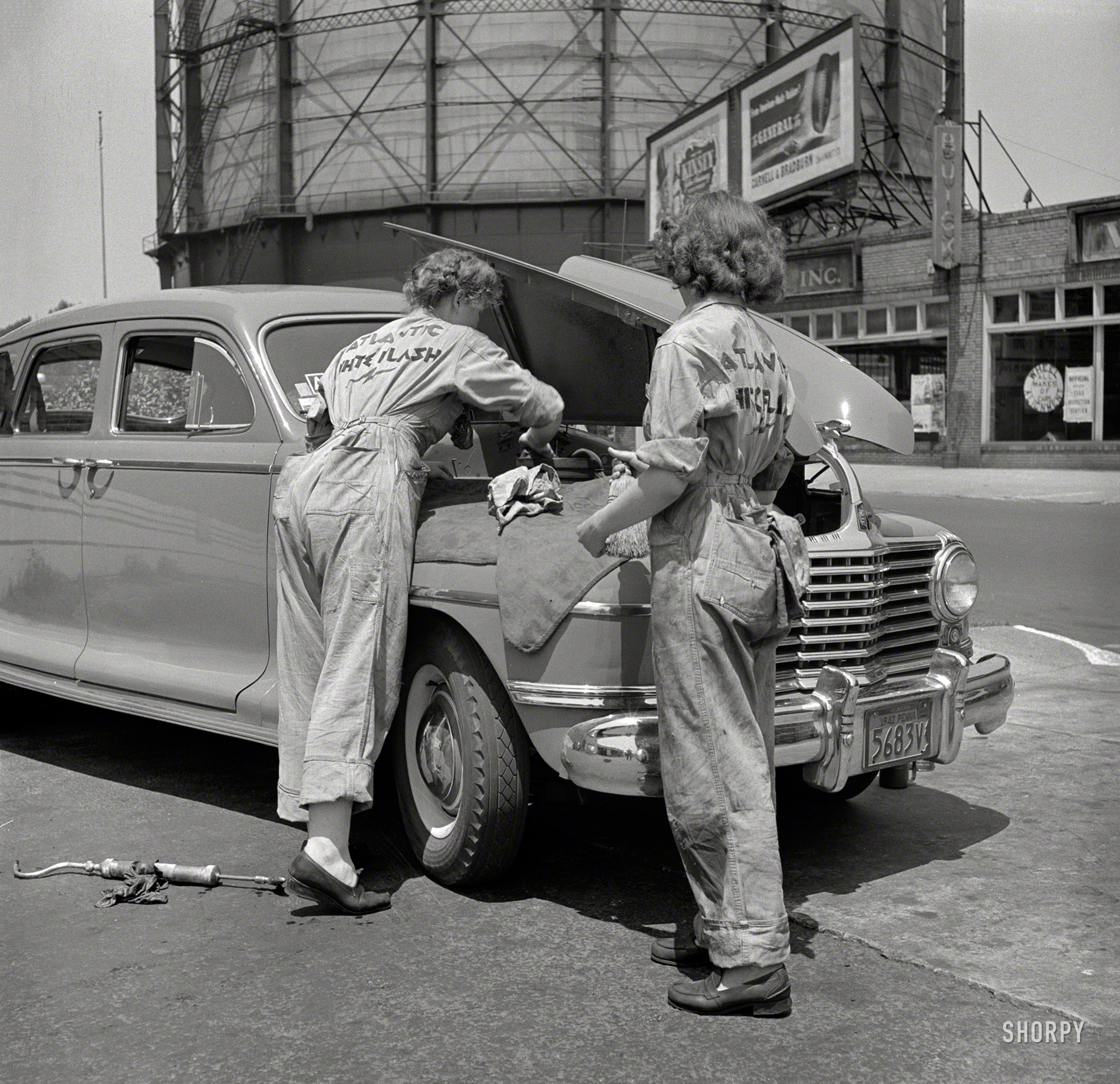 June 1943. "Philadelphia, Pennsylvania. Women garage attendants at the Atlantic Refining Company." The hard part here was figuring out that crazy clamshell hood. Photo by Jack Delano for the Office of War Information. View full size.