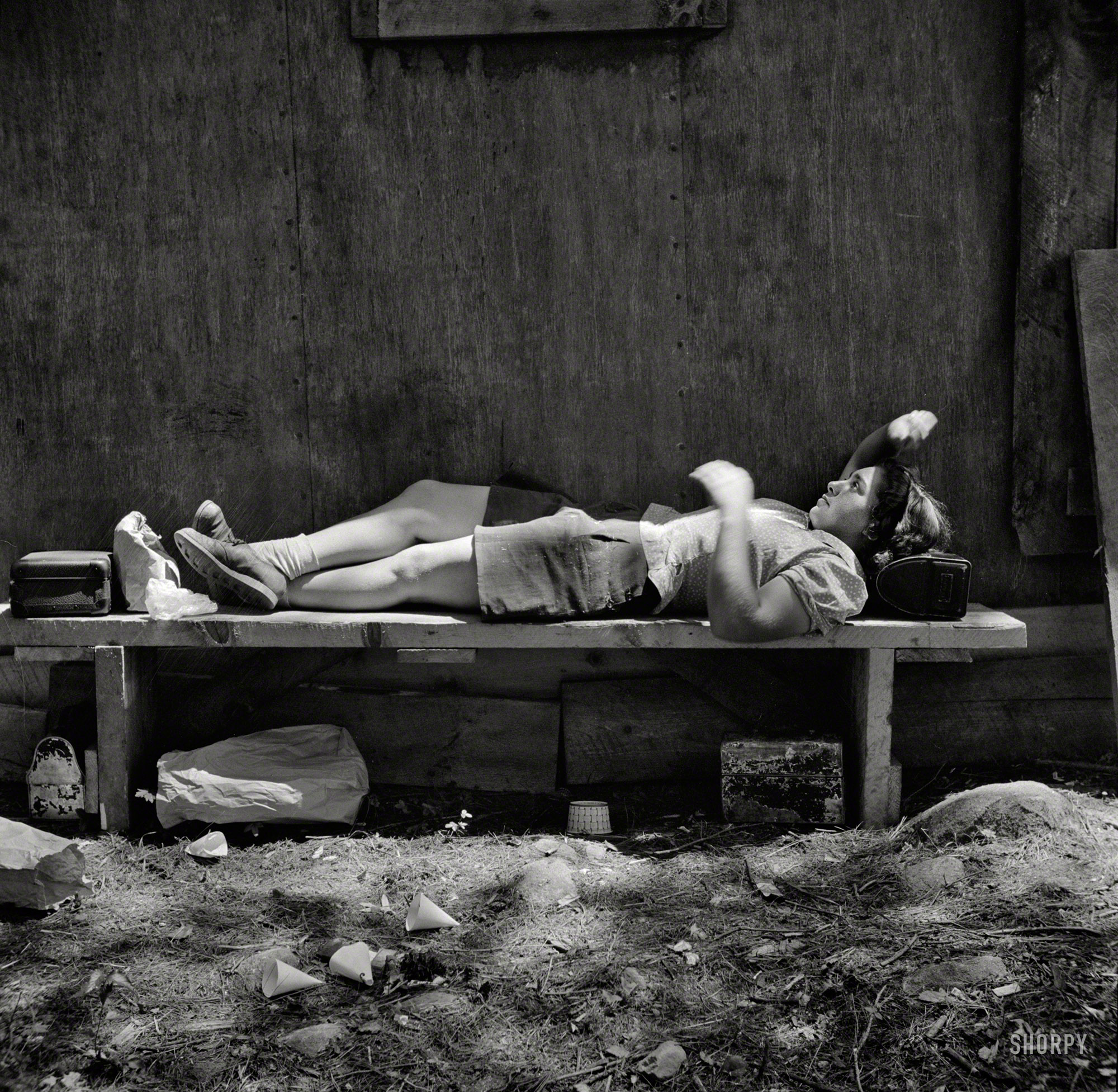 June 1943. "Turkey Pond, near Concord, New Hampshire. Women workers employed by a Department of Agriculture timber salvage sawmill. Ruth De Roche, 18-year-old 'pit woman,' resting her head on her lunch pail during the lunch hour." Photo by John Collier for the Office of War Information. View full size.