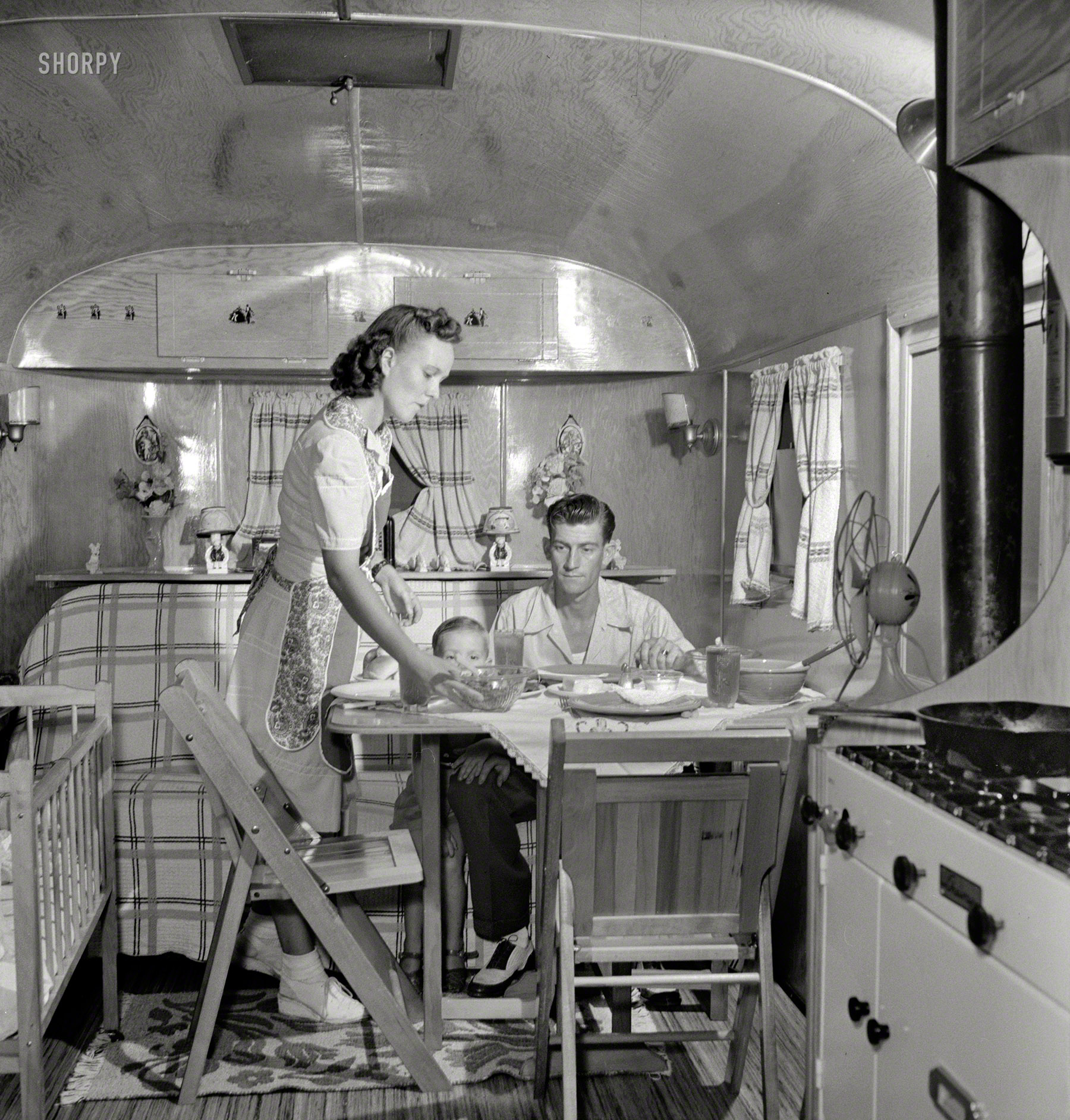 August 1943. "Middle River, Maryland. A Farm Security Administration housing project for Glenn L. Martin aircraft workers. A worker's family in their trailer home." Photo by John Collier for the Office of War Information. View full size.