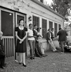 September 1943. "A Greyhound bus trip from Louisville, Kentucky, to Memphis, Tennessee. Idlers in front of the bus stop between Memphis and Chattanooga." Photo by Esther Bubley for the Office of War Information. View full size.