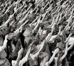 May 1942. "Southington, Connecticut. Schoolchildren pledging allegiance to the flag." Photo by Fenno Jacobs for the Office of War Information. View full size.