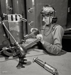 December 1942. "Mary Miller, operator of a router at the Boeing plant in Seattle, drills holes in a part for a new B-17F (Flying Fortress) bomber. The Flying Fortress, a four-engine heavy bomber capable of flying at high altitudes, has performed with great credit in the South Pacific, over Germany and elsewhere." Photo by Andreas Feininger for the Office of War Information. View full size.