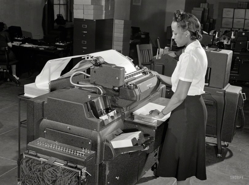 June 1942. Washington, D.C. "U.S. Office of Defense Transportation system of port control and its traffic channel control." IBM printer connected to a punch card machine. Photo by Albert Freeman, Office of War Information. View full size.
