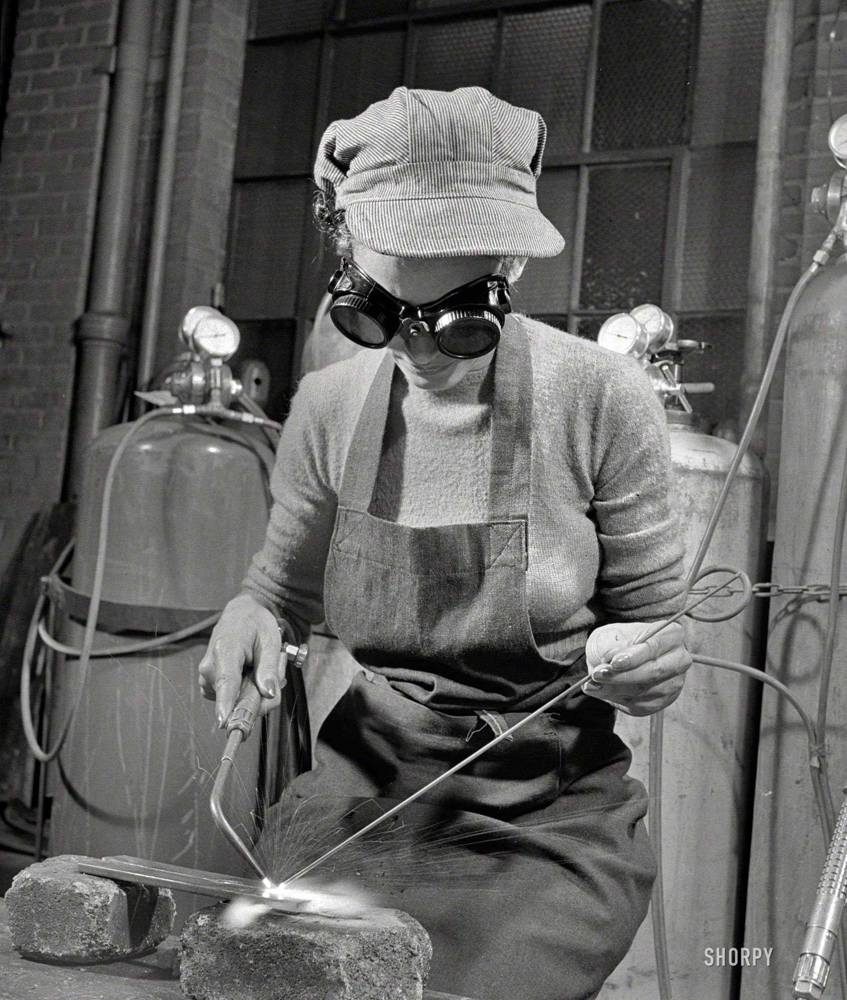 &nbsp; &nbsp; &nbsp; &nbsp; This young lady is training to work on the assembly line of one of our great war plants. In preparation for this task, she devotes six nights a week to a WPA vocational training school where experienced instructors show her the technique of modern welding.

July 1942. "Work Projects Administration vocational school in Washington, D.C." Photo by Howard Liberman, Office of War Information. View full size.

