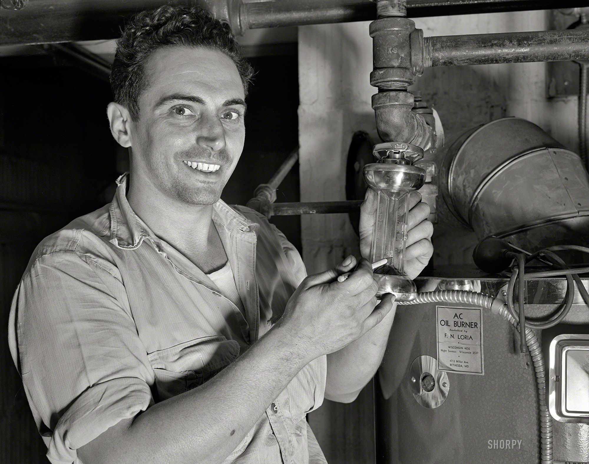 Circa 1942, in the vicinity of Washington, D.C.: "Conservation of fuel oil." When the tradesman takes that pencil from behind his ear and uses it as a pointer, you know he's telling you something important. No photographer credit but we will guess Ann Rosener for the Office of War Information. View full size.