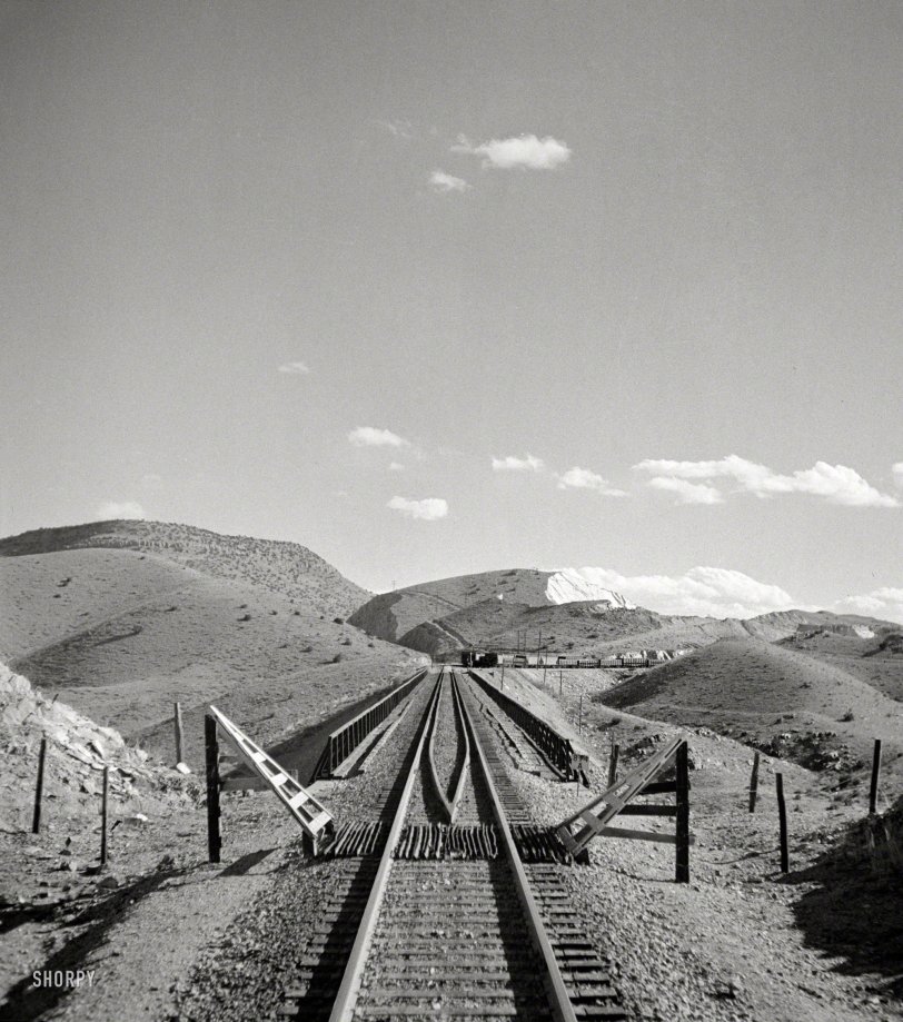 March 1943. "Coming out of the mountains on the Atchison, Topeka &amp; Santa Fe between Vaughn and Belen, New Mexico, into the Rio Grande River Valley. In the distance is a quarry on the mountainside where the railroad gets its rock for ballast." Photo by Jack Delano, Office of War Information. View full size.
