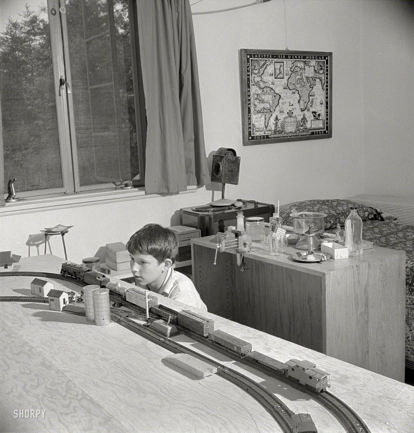 June 1942. "Greenbelt, Maryland. Child's bedroom in which a 13-year-old boy has rigged up model trains and a chemical laboratory." Johnny's next project: Discover girls. Photo by Marjory Collins for the Office of War Information. View full size.
