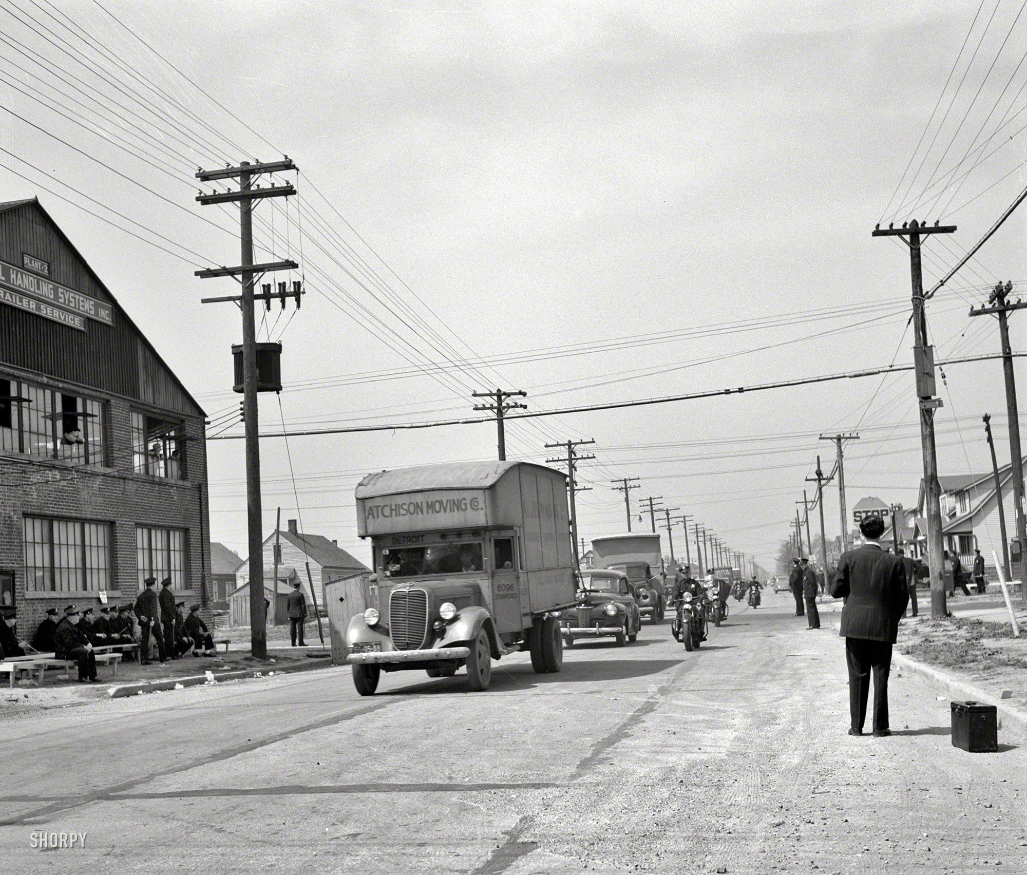 February 1942. Detroit, Michigan. "Riot at the Sojourner Truth Homes, a new U.S. federal housing project, caused by white neighbors' attempt to prevent Negro tenants from moving in. Moving vans convoyed by police department moving Negroes' furniture." Photo by Arthur Siegel. View full size.