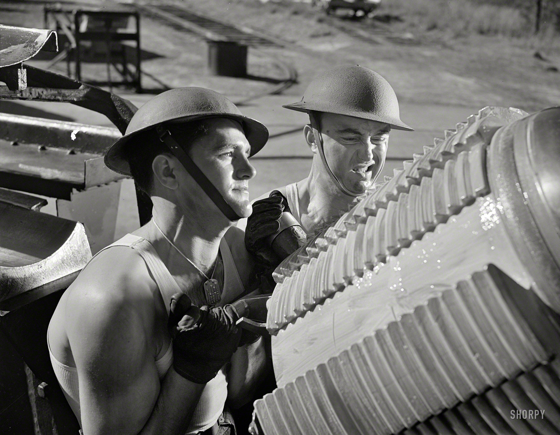 March 1942. Virginia Beach, Va. "Fort Story coast defense. A tough job for soldiers is shoving the breech block of the giant howitzer into place. The screw threads help the block to withstand millions of foot-pounds of pressure caused by the exploding charge." Photo by Alfred Palmer, Office of War Information. View full size.