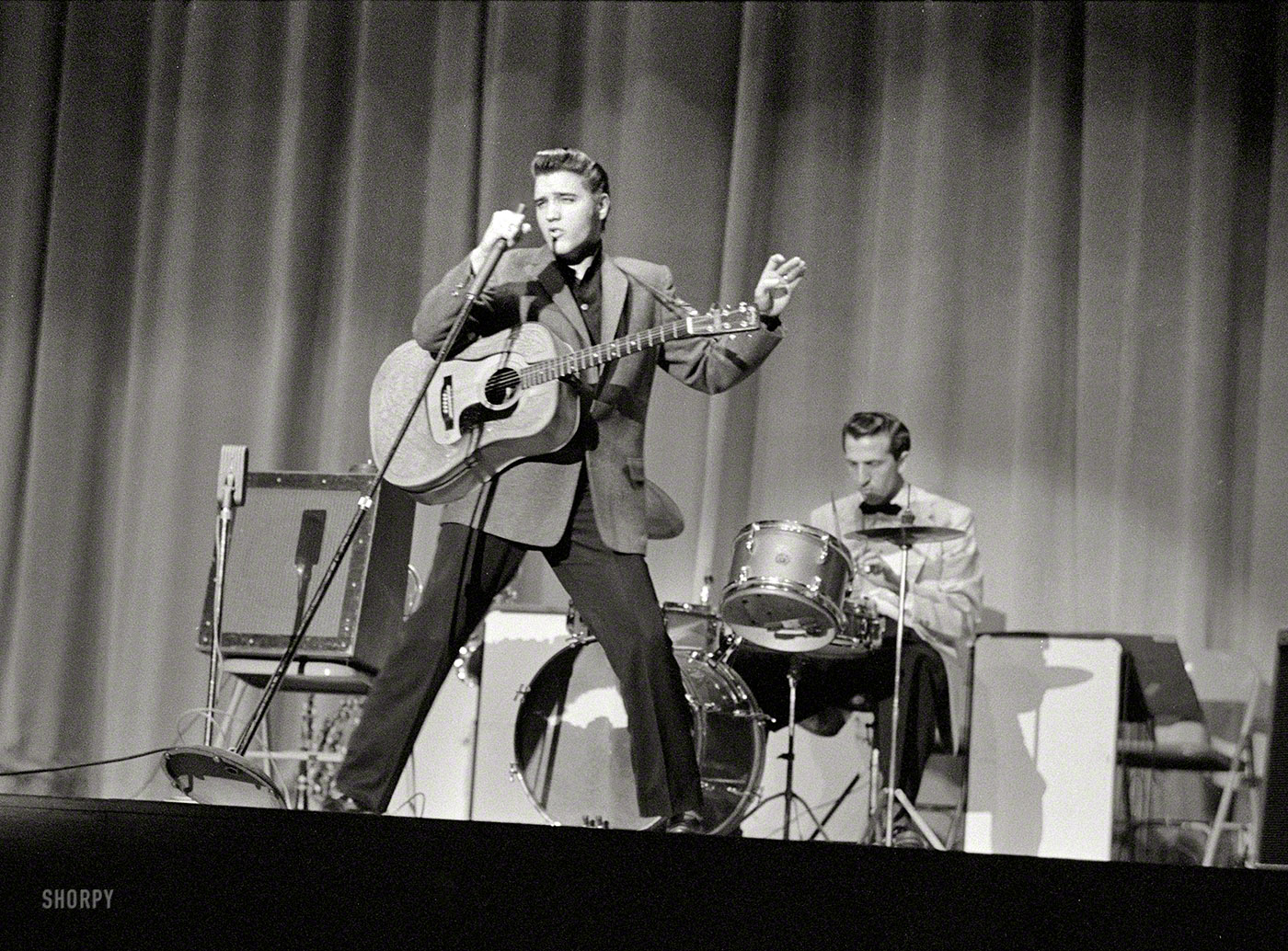 Elvis Presley at a 1956 concert date; we're counting the minutes until someone can tell us which one. Photo by Phillip Harrington for Look. View full size.