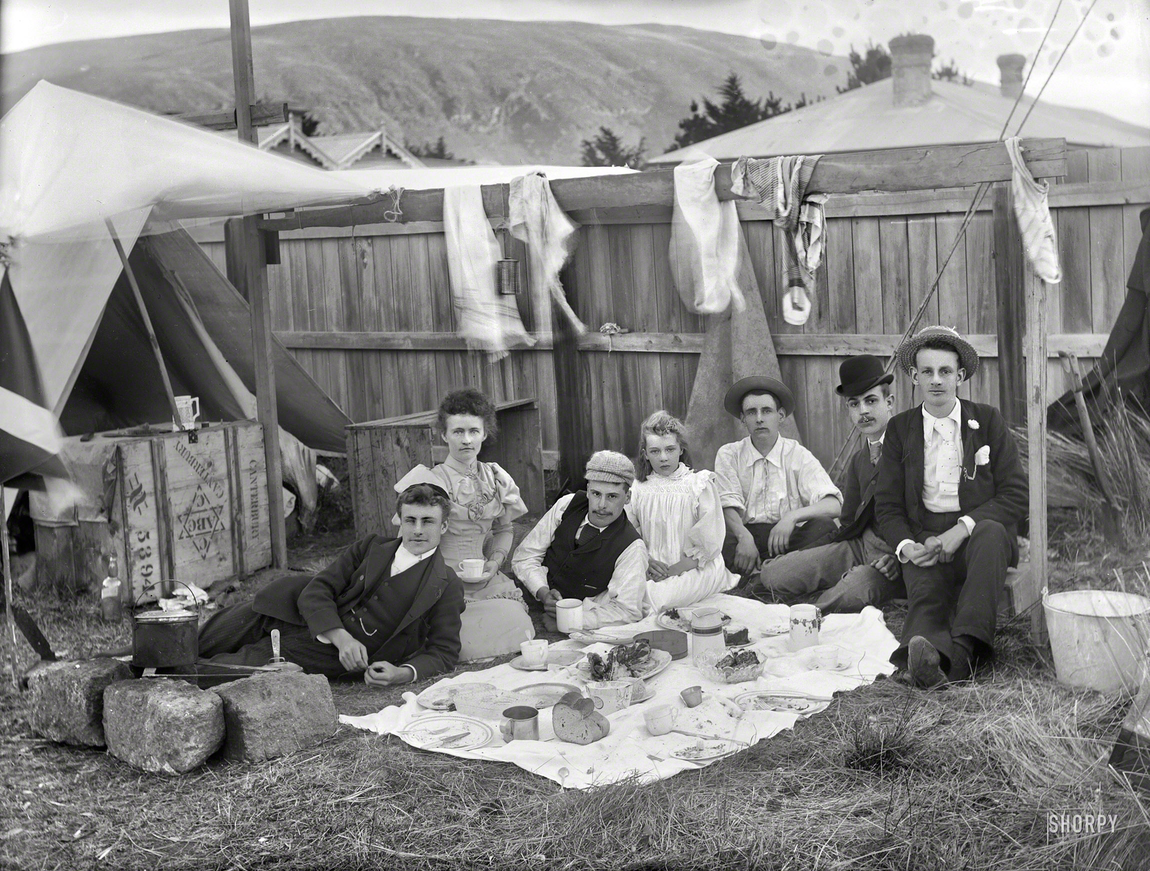 New Zealand circa 1905. "Unidentified group having a picnic outside tent in backyard of house, probably Christchurch district." Are New Zealanders the most picnicking people on the planet? Glass negative by Adam Maclay. View full size.