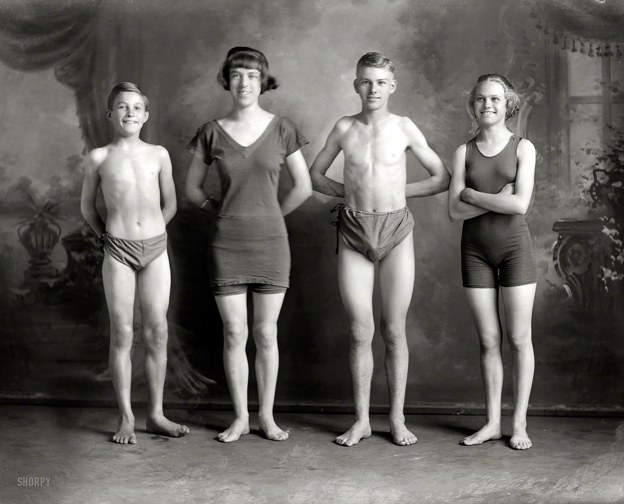Circa 1920, more trend-setting swimwear from New Zealand. "Young people in swimming costumes, Christchurch." Glass plate by Adam Maclay. View full size.