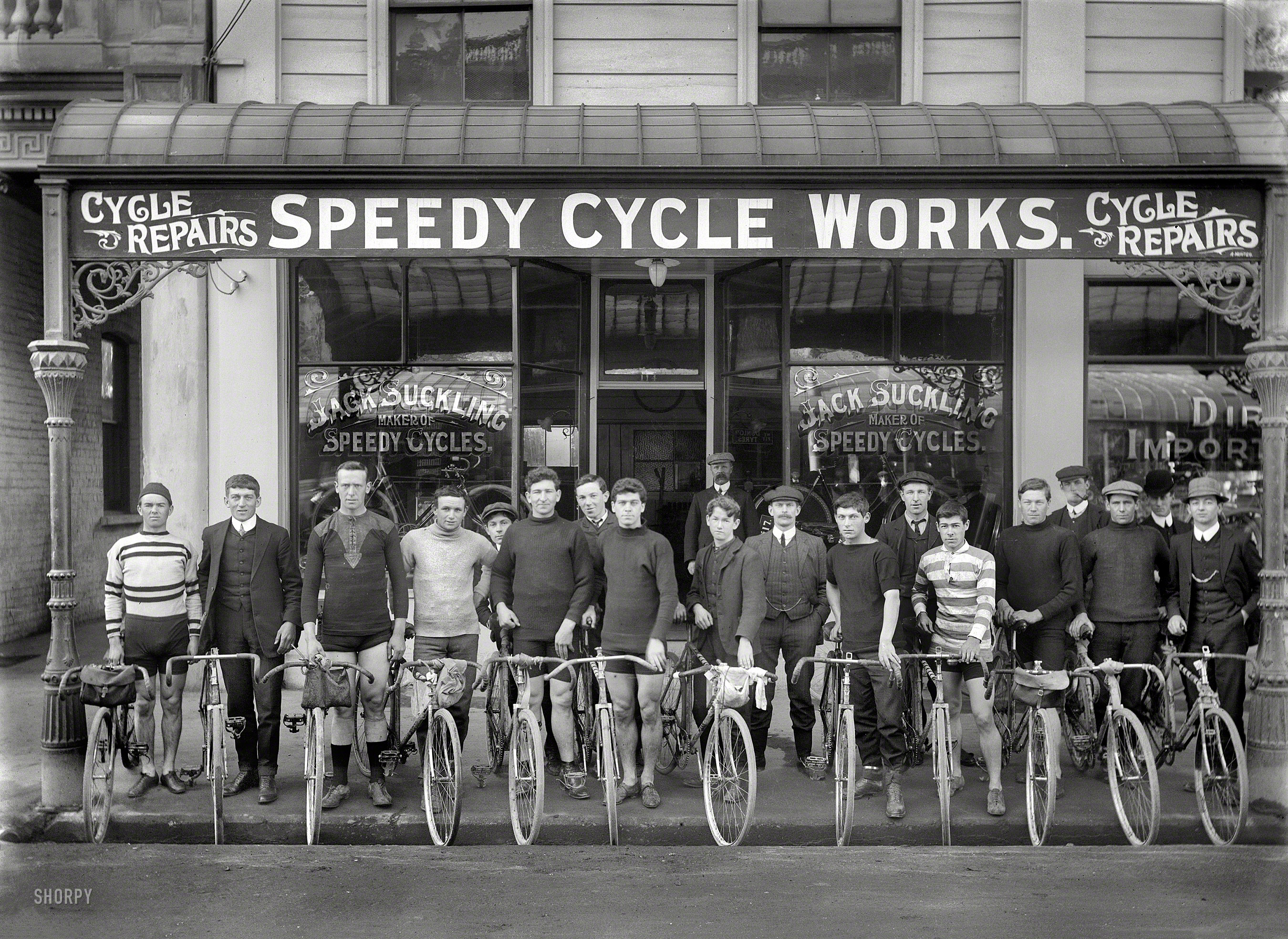 Christchurch, New Zealand, circa 1913. "Jack Suckling (center right with watch chain) and cyclists outside Speedy Cycle Works, Manchester Street. Champion cyclist Phil O'Shea is third from right." Photo by Adam Maclay. View full size.